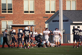 Football players run to tackle the other team to prevent them from scoring. Photo by Sammi Beeler