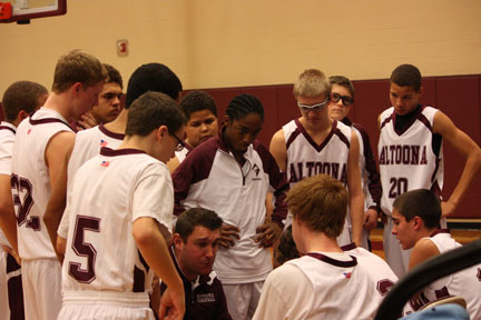 The Altoona White Ninth grade team huddling up during a time out.  The team defeated State College to win their second game of the season