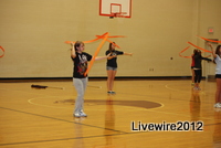 Ninth grader Anna Zettle twirls her ribbon around during the beginning of her routine. Photo by Emily Glacken