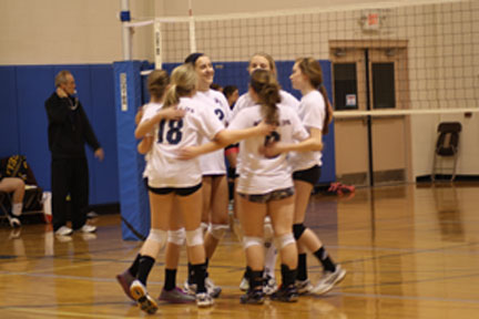 Kylee Clawson, Andrea Parrish, Rachel Borst, Lydia Greaser, Sidney Puhatch and Micaleigh Noll bring it in after a hard fought rally.  The players do this after every single play.  Photo by Arian Savoy.  