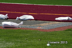 The workers put bags on the turf so that it does not curl up through out the night. Photo by Tyler McCloskey