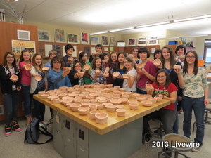 Community Inspired Arts club members stand together holding the bowls they made for the empty bowls program.
~Photo by Ann Bickel