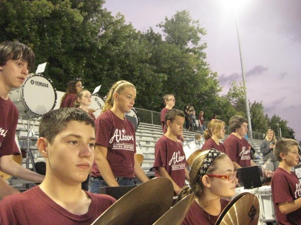 The schools percussion section playing cheers on a game day