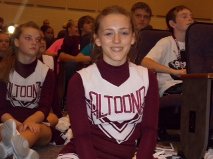 Sara Sohmer, ninth grader, sits patiently on the ground while a skit is being shown. She smiles to get everyone pumped up and excited.
Photo By: Hanna Feathers