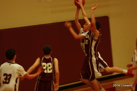 Foul! Ninth grader, Trey Barr, goes in for a lay-up as ninth grader, Connor McCloskey, tries to block the shot. Photo by Hanna Feathers