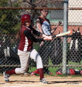 Ninth grader, Caitlyn Palazzi, hits the ball out to the outfield. She was the shortstop for the the whole game. Photo by Hannah Barr
