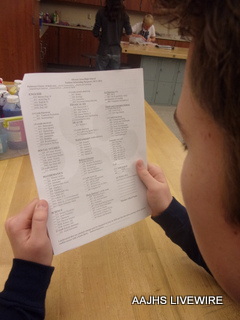 Sam Wyland looks over schedule paper that was sent out in the mail with 2nd marking period IGRs.  Concentrated, he thought about which classes and liked and which classes he didnt like.   