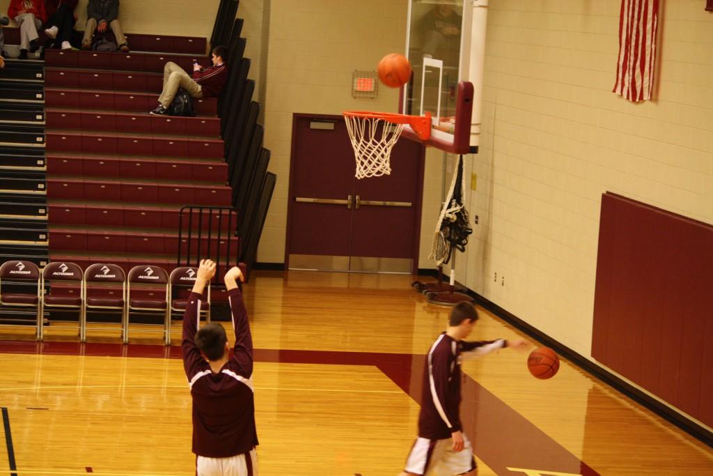 Ninth grader, Max Sankey warms up with some free throws before their basketball game

Photo taken by: Emily Simmons