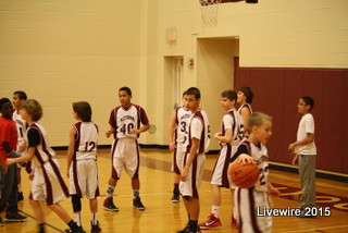 Seventh grade white boys basketball team waits patiently for the referee to call a foul.  The game was played on Jan. 7, 2015 and they went up against State College.  
