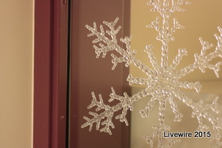 In the hallway of the ninth grade floor, a Christmas decoration
hangs in the window.  A plastic snowflake stuck to the window
of a ninth grade teacher’s classroom. 