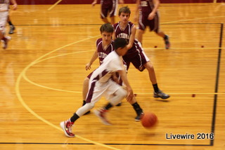 Alex Colbert dribbles around opposing player AJ Bardelang.