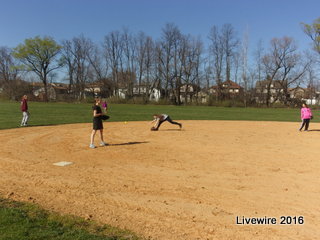 This is at practice, one of the girls runs and reaches down to get the ball as it goes by.  Taken by Mr. Mitchell. 