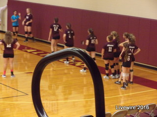 Action! The team formed a line to practice some drills before the game to make them prepared.  They were a better team that game which resulted from their drills. 