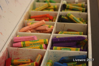 One of the eighth grade art classes begins a new project working with oil pastel crayons. Oil pastels are used for painting and drawings and the colors on the canvas will blend when you rub your finger over the colors. 