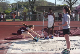 Prepare for landing! Ninth grader Gianna Caputo gets ready to land in the sand pit. Long jump is a track and field event where athletes leap as far as possible from a takeoff point on a runway. 