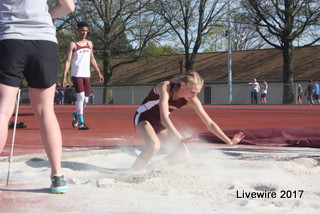 Freshman Anna Rupp jumps into the sand pit during the long jump event. Long jump is an event that can be competed by both men and women.