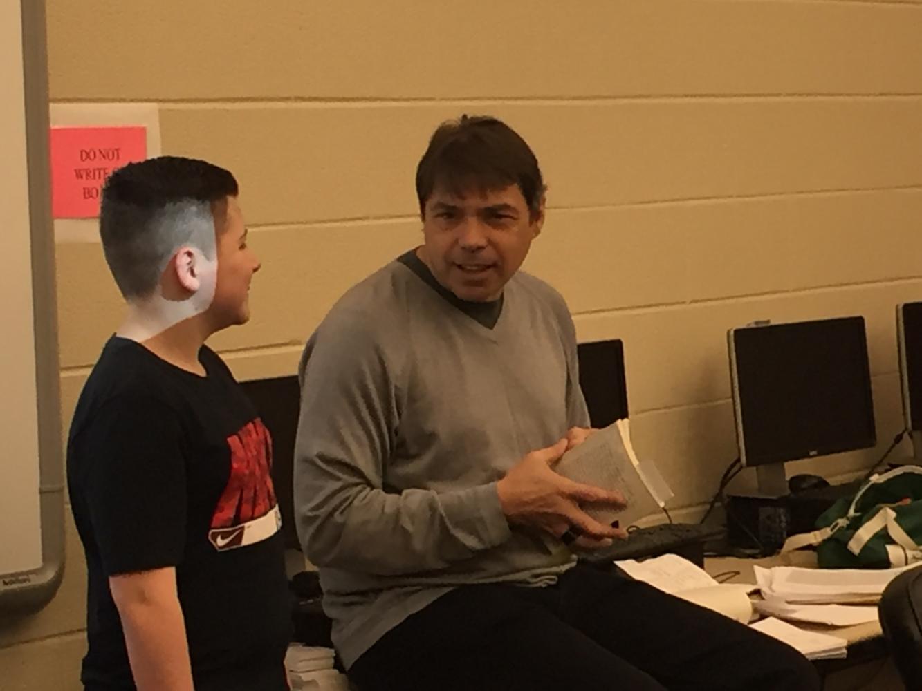 Author Paul Volpini speaks with seventh grade student Brenden Grimminger during his visit.