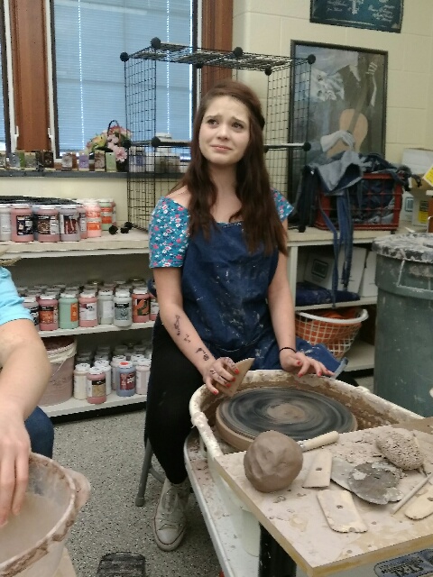 Wow! Reporter Lily Miller tries pottery for the first time by watching Jessica Helsel make a bowl.  The look on her face pretty much shows how some students feel when facing the wheel for the first time.  