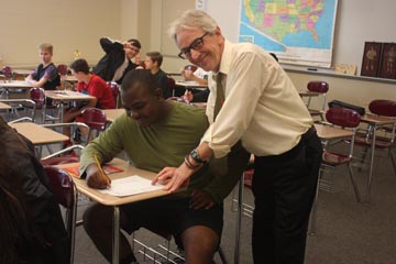 Teacher Don Church works with Javionne Davis during one of the last few days of the school year and his teaching career.