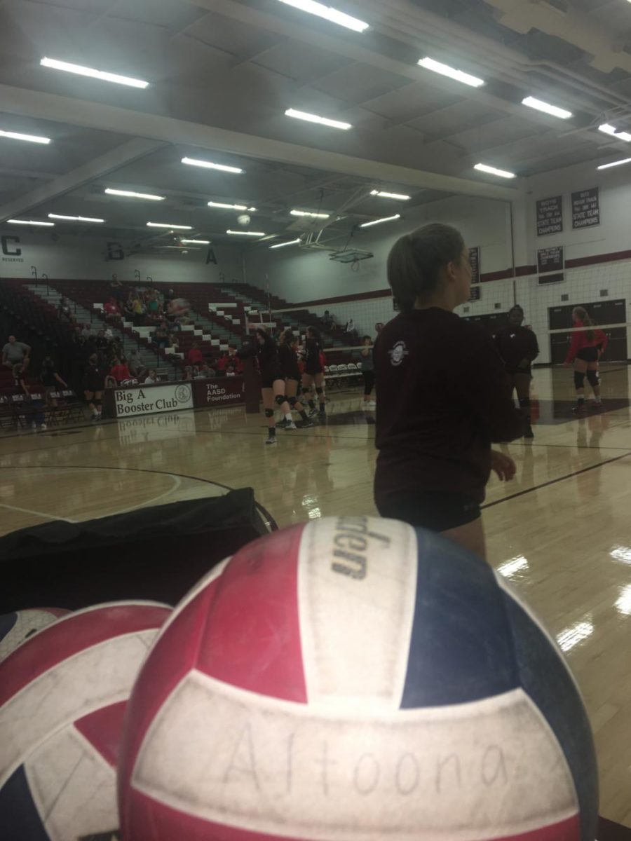 Hit! Defensive specialist Kayla Clawson watches her team warm up and makes sure everyone's on track. The girls put in their best effort but lost 3-0 to rivals Paunxatawney on Thursday, the 21st. Varsity played at 7:00pm. Great effort girls! Photo taken by Sarah Weathersbee.