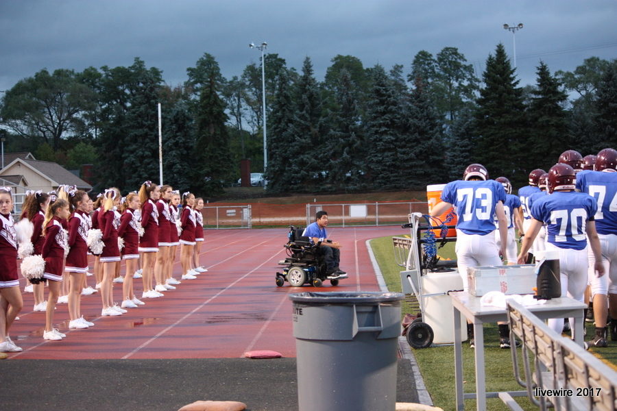 The cheerleaders and football players prep before the  throw back thursday game. 
