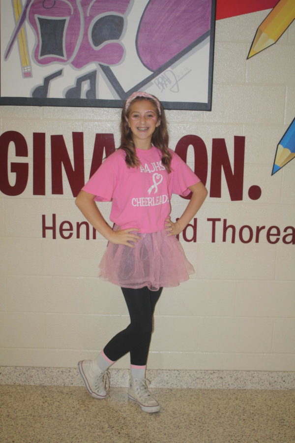 Laney Degennaro, ninth grader, shows her spirit during the pink out on thursday. The pink out helped raise awareness for breast cancer.