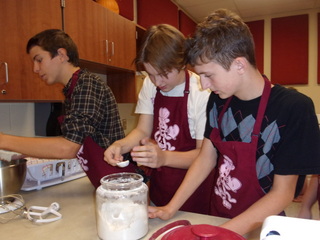 Measure! Chuck Ketterman and Nate Green use measuring spoons to measure the right amount of flour to put into their pizza. The lab took two days for the making and cooking process. The first day was Oct.26.