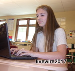 Ninth grader, Morgan Baker, works on her Chromebook during class. She is typing an essay for her Civics class. 