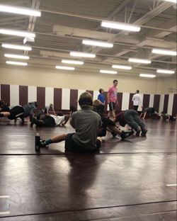 The wrestlers practicing after school to prepare  for future matches.