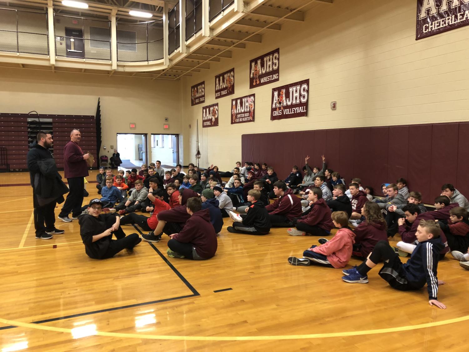 Head coach Chesney describes the procedure for practice before they head out on the field. The boys are preparing for their first meet.