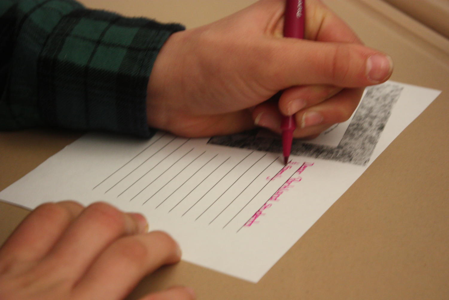Students in Makenzie Wilt's eighth grade classroom write postcards to Parkland students after viewing the television segment created by AAHS students.