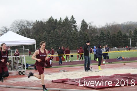 Rush. Andrew Carini runs the 1600 meter dash at the track meet on April 3. Carini ran then waited for his next event.