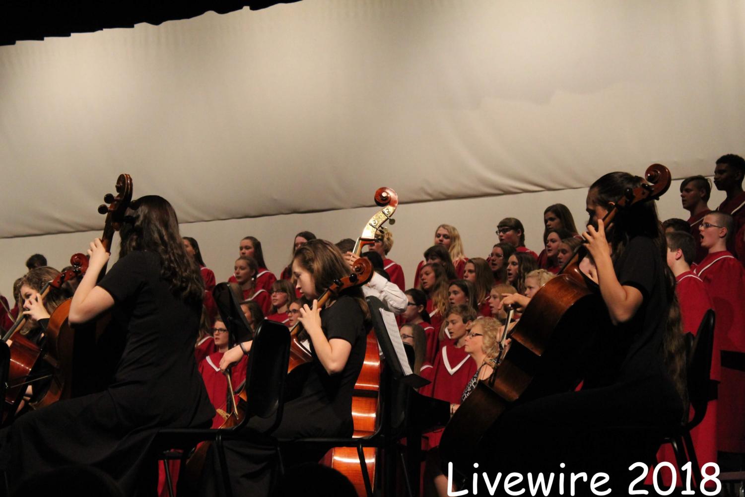 Play! The seventh grade orchestra and chorus sing and play the song,