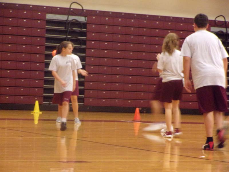 Prepare for Impact!
The football thrives in the students hand before he makes a pass.  The fourth period gym class for our school played ultimate football in the gymnasium last week.
