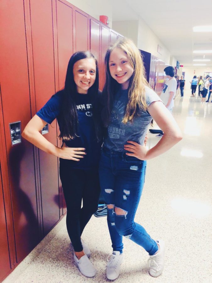 Rivals go head to head!  Gracie Weaver and Emma Girgany show their school spirit by wearing their favorite college sport team. College sport day was on Wednesday, Oct. 10.
