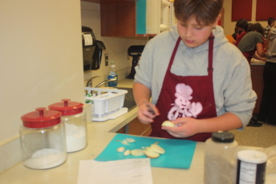 Cut it up!  Landen Hauser cuts an onion up to add in his meal. Foods class lasted for a semester.