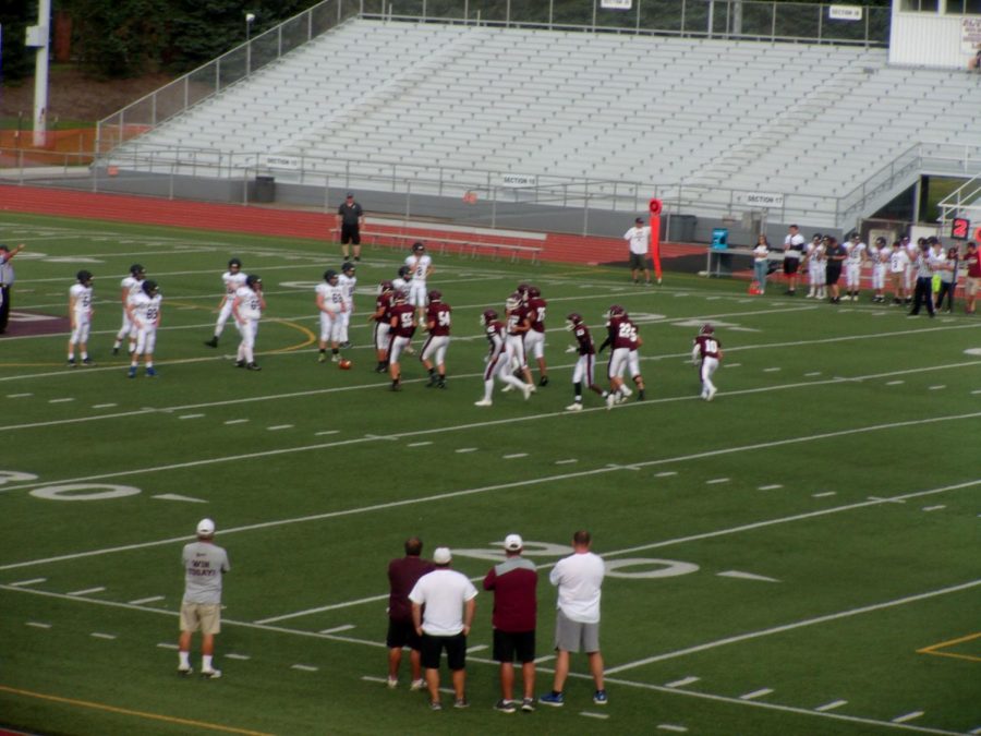 Getting Started  The maroon football team plays in a game. 