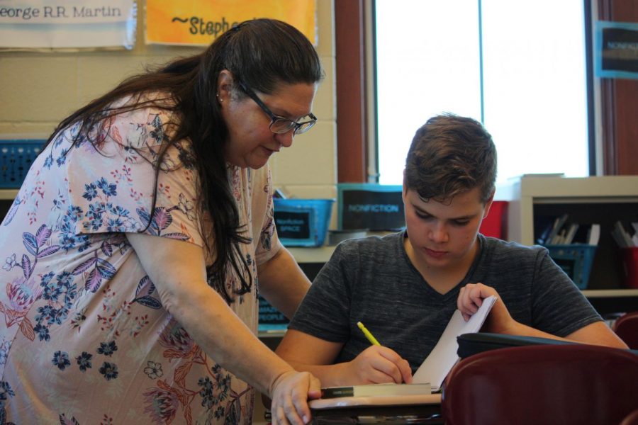 Read All About It!  Heidi Bardelang encourages, eighth grader, Anthony Jablonski with his book. Jablonski has been participating in reading workshop.