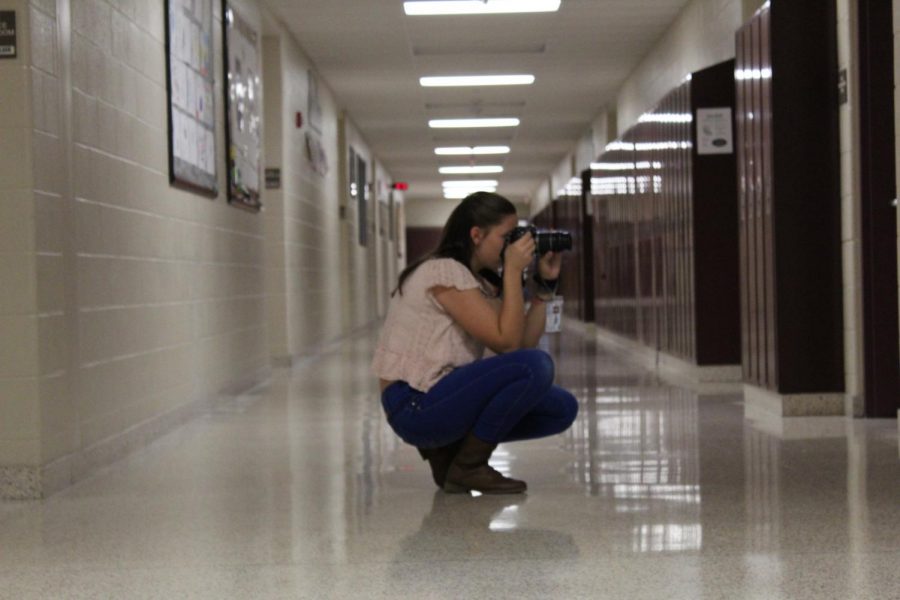 Student reporter Danielle Bardelang takes photographs for an upcoming story on Livewire. Junior high news reporters take photos and write stories for the schools newspaper.