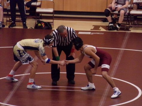 Rivalry Pablo Rojas faces off against a Hollidaysburg opponent. The referee signaled for the match to begin.