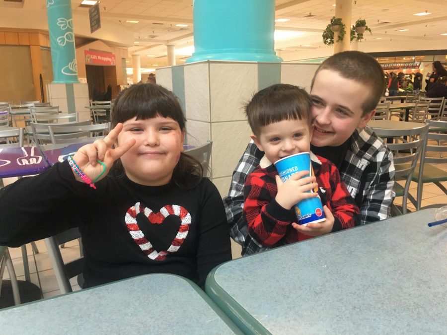 Henry Lohsl and his two siblings pose for a picture at the Logan Valley Mall. Henry remembers when he was able to get out of the house and share time with his siblings.