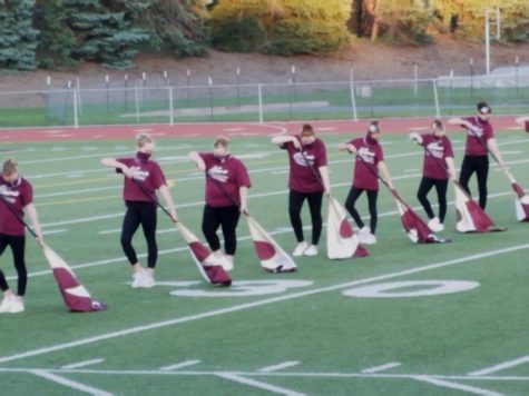  Silks, position! This year’s silks perform their routine for the “Star Spangled Banner. The girls trained all summer and finally showcased their skills for the crowd at this year’s marching band showcase October 16, 2020.
