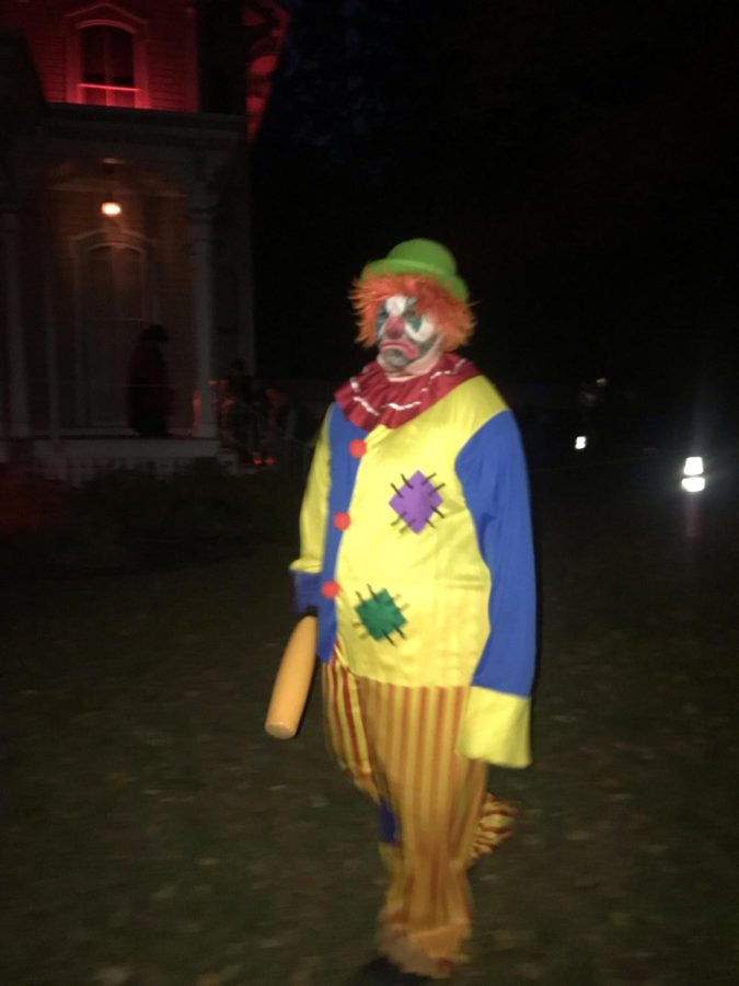 There was a clown walking around the room.Then he opened the door to outside