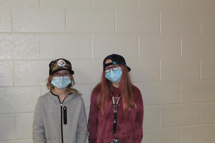Two girls from six grade was smiling under there masks while taking this picture.