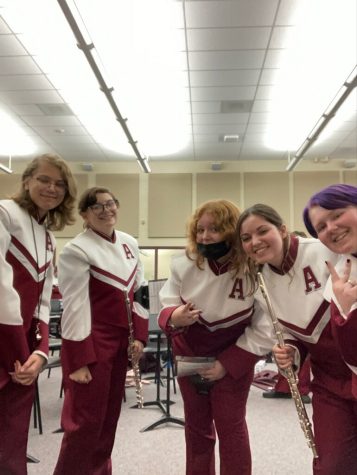 Eighth graders Caleb Terza, Gracelynn Beldin, Mileena Setzer, Madison Aboud and Chloe Kessling get into uniform and prepare for a football game.