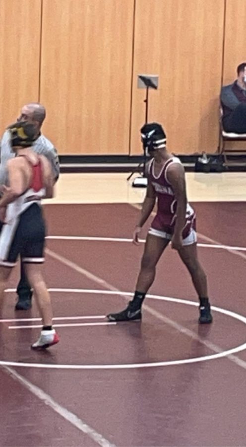 Eighth grader Julian Pringle comes to the circle to wrestle his opponent.  