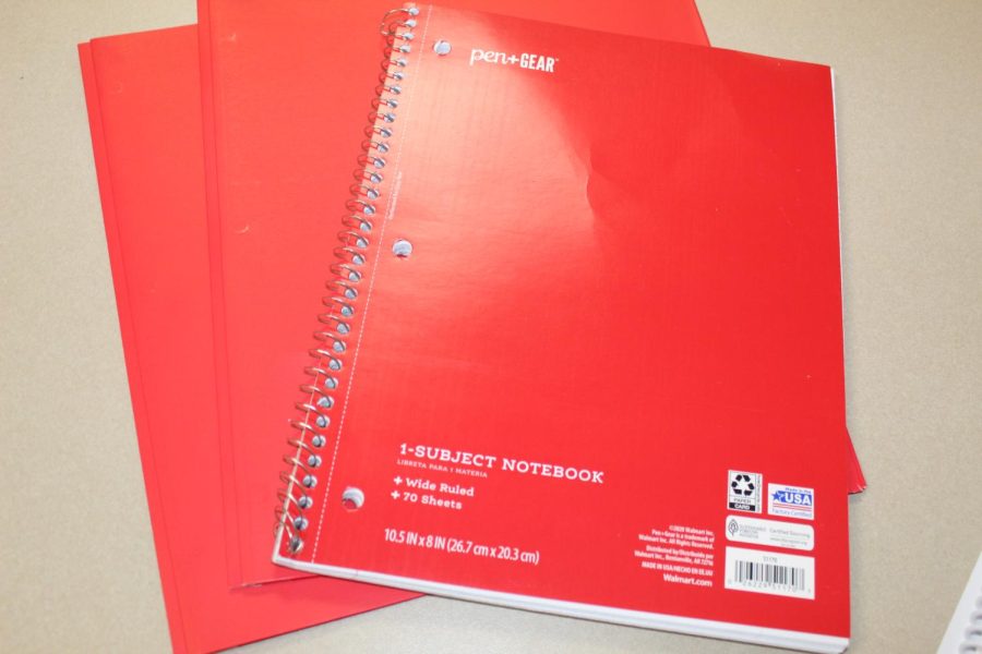 Has two red folders. One red notebook provided to students 
 to be place in the binder.