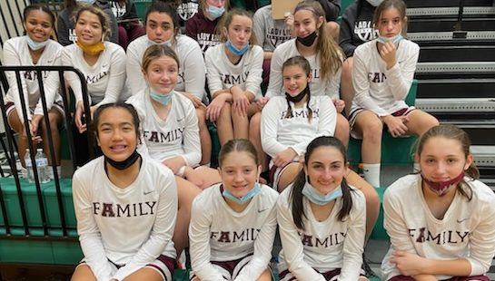 The team poses in the Central Dauphin gym after winning their game. The girls played hard and won their game by 3 points. After their game, they went over to the other gym to watch the high school girls team play.