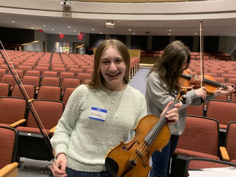 Excited%21+Seventh+grader+Kinsley+Palilla+grins+for+a+picture+before+the+other+schools+arrive.+The+festival+took+place+in+the+high+school+where+the+students+practiced+until+the+concert+started+at+7+p.m.