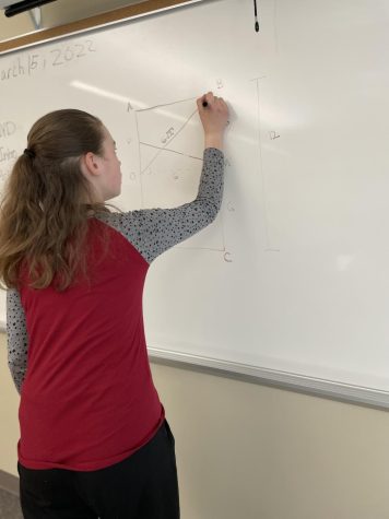 Melissa Krainer works to solve a difficult math problem to prepare for the competition. 
